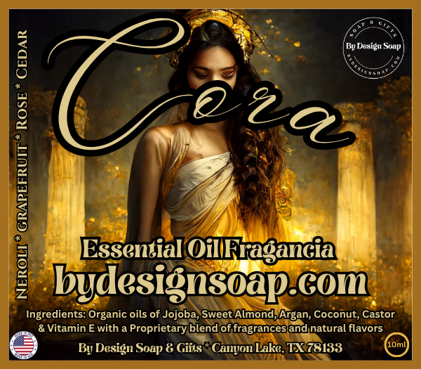 Advertisement for 'Cora' Essential oil fragrance with the image of a woman in a golden dress in the background. Made in the USA label.