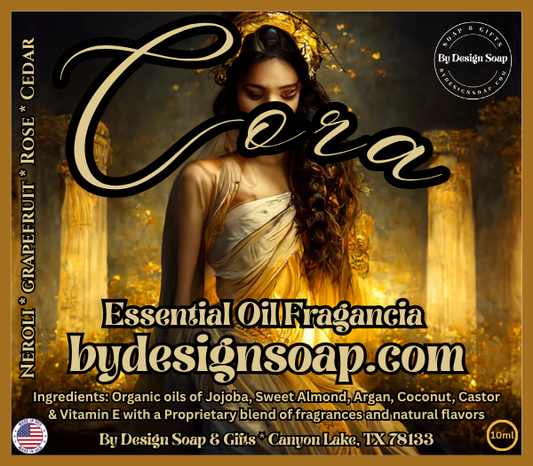 Advertisement for 'Cora' Essential oil fragrance with the image of a woman in a golden dress in the background. Made in the USA label.