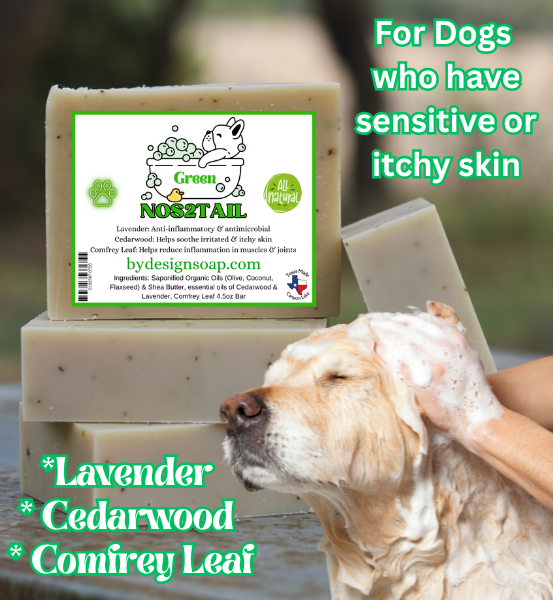 Image of a Lavender, Cedarwood and comfrey leaf dog soap with the text, "NOS2TAIL" for dogs who have sensitive or itchy skin and the image in the foreground of a dog being bathed.