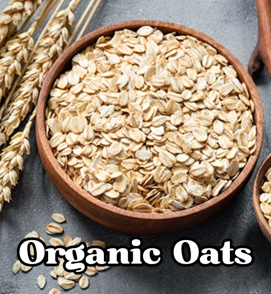Wooden bowl filled with organic oats on a dark surface surrounded by wheat stalks and the text 'Organic Oats'