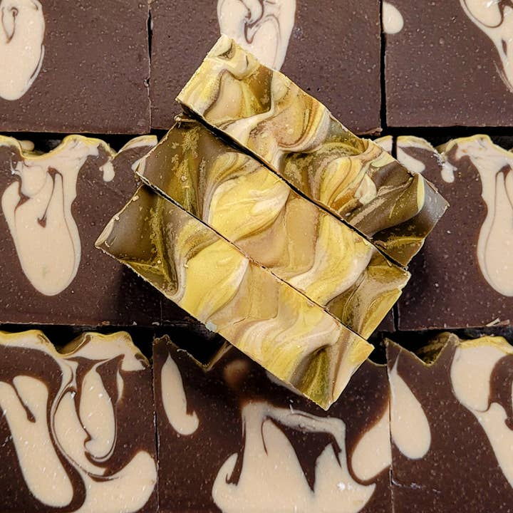 Image of eleven dark brown with cream marble homemade soaps.